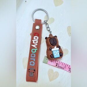 Peruvian Capybara holding a bubble tea Keychain with Brown Strap
